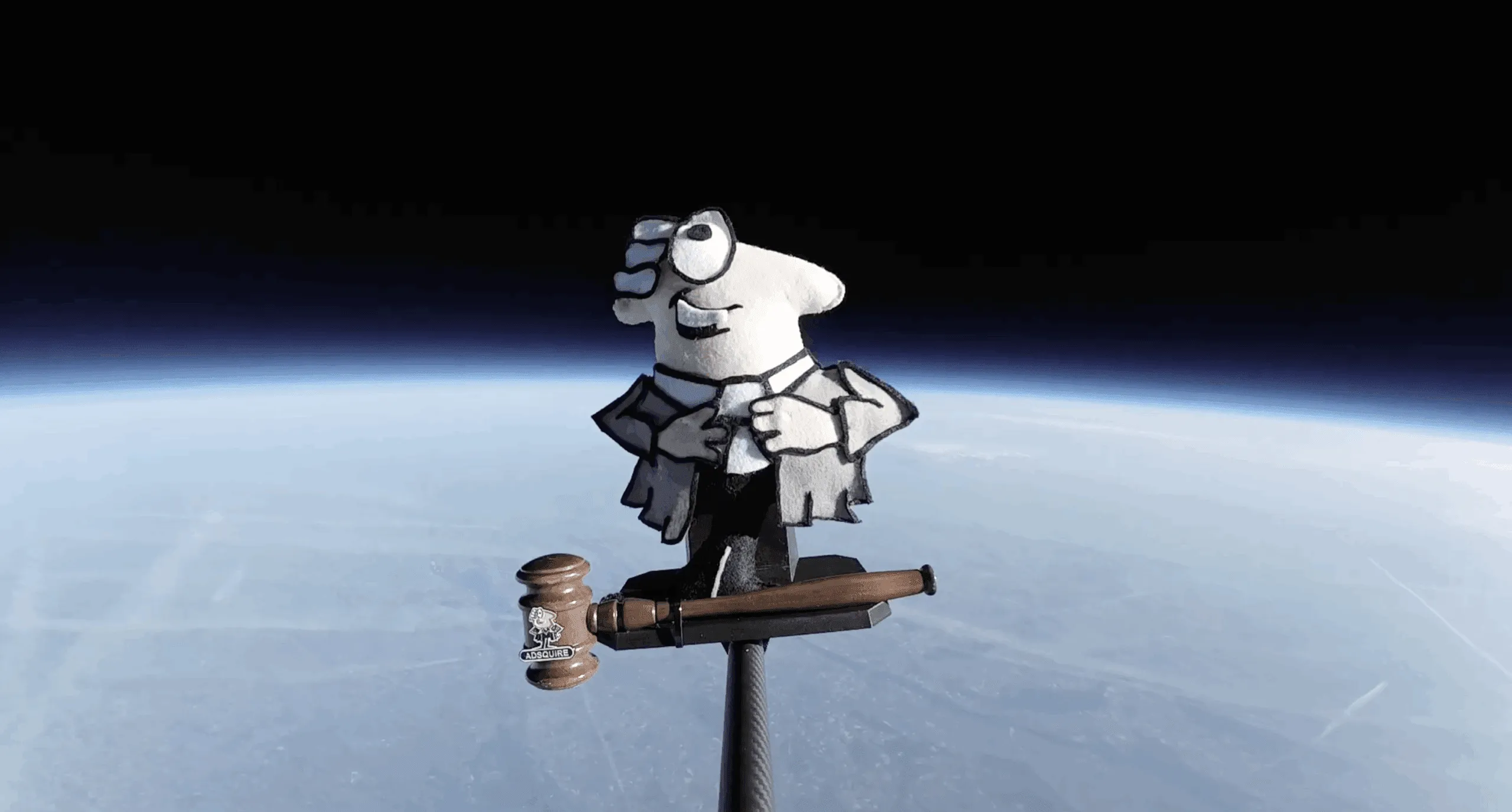 ADSQUIRE mascot high above the Earth
